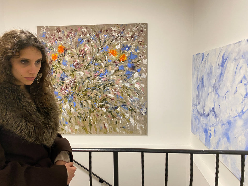Bianca Raffaella at TKE Studios, in front of two of her paintings 'Impressions' (left) and 'Into the Blue'.